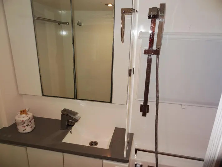 Good Times Yacht Photos Pics Modern bathroom with sleek fixtures, mirrored cabinet, and shower in a 2020 Leopard 45 model.