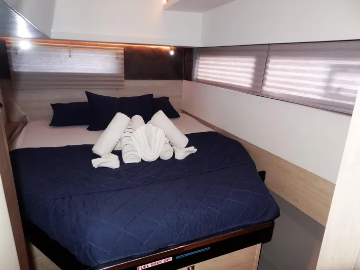 Good Times Yacht Photos Pics Cozy bedroom in 2020 Leopard 45 yacht with navy bedding and neatly arranged towels.
