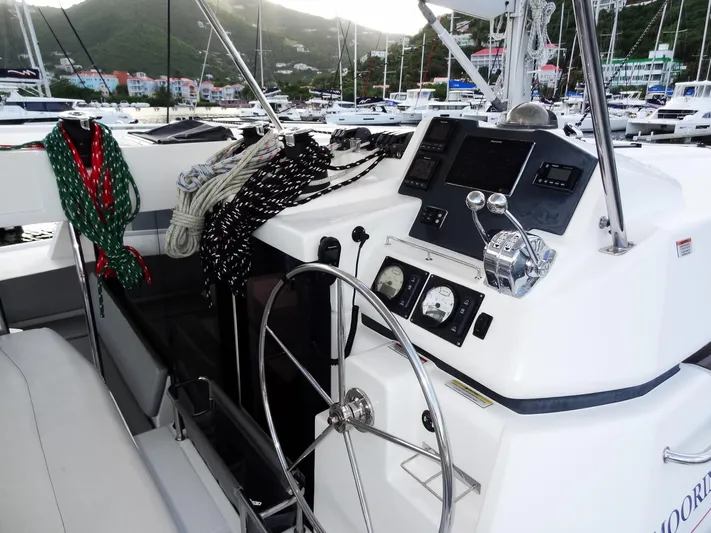 Good Times Yacht Photos Pics Helm of 2020 Leopard 45 catamaran with ropes and control panel in marina setting.