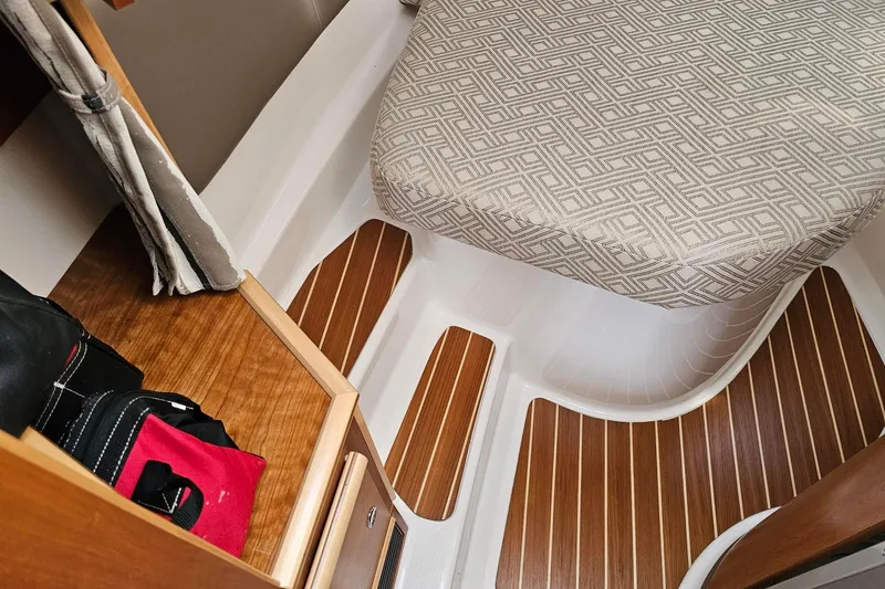 Frisky Yacht Photos Pics 2022 Cuwater C-32-CB interior with patterned seat and wooden flooring.