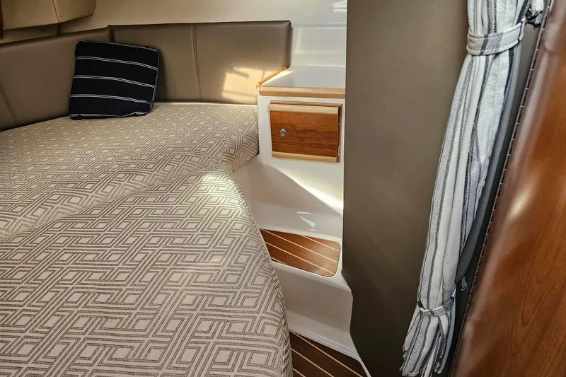 Frisky Yacht Photos Pics Cozy cabin interior of 2022 Cuwater C-32-CB with patterned bedding and wooden accents.