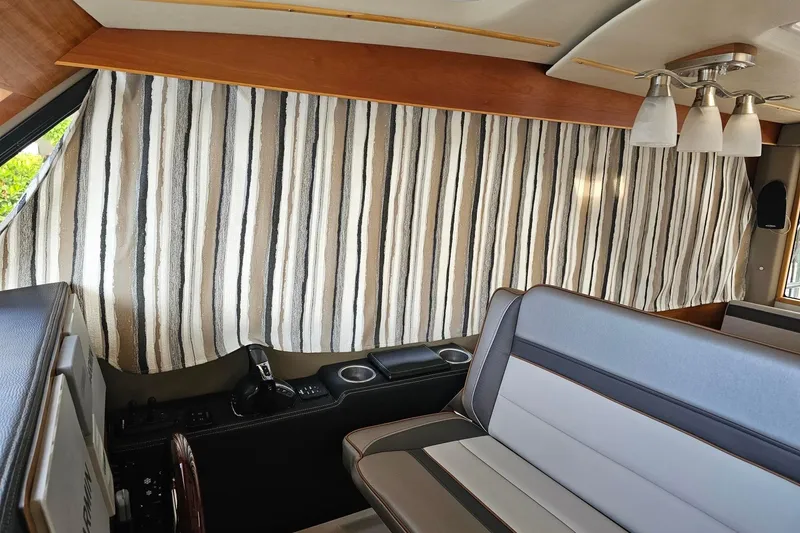 Frisky Yacht Photos Pics Interior of 2022 Cuwater C-32-CB with striped curtains and modern seating.