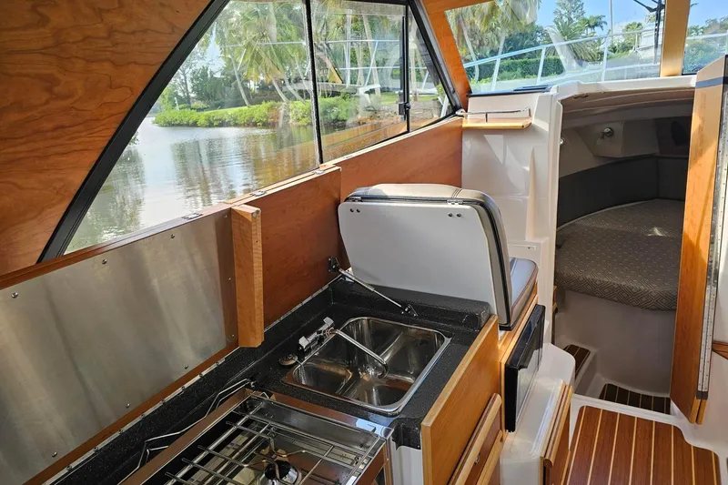 Frisky Yacht Photos Pics Interior of 2022 Cuwater C-32-CB boat with kitchenette and cozy cabin.
