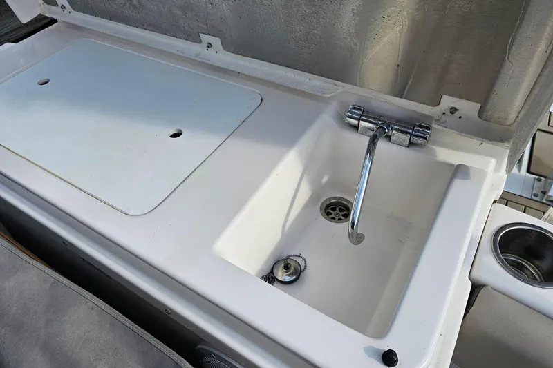 Frisky Yacht Photos Pics Boat sink and counter on 2022 Cuwater C-32-CB, featuring chrome faucet and drain.