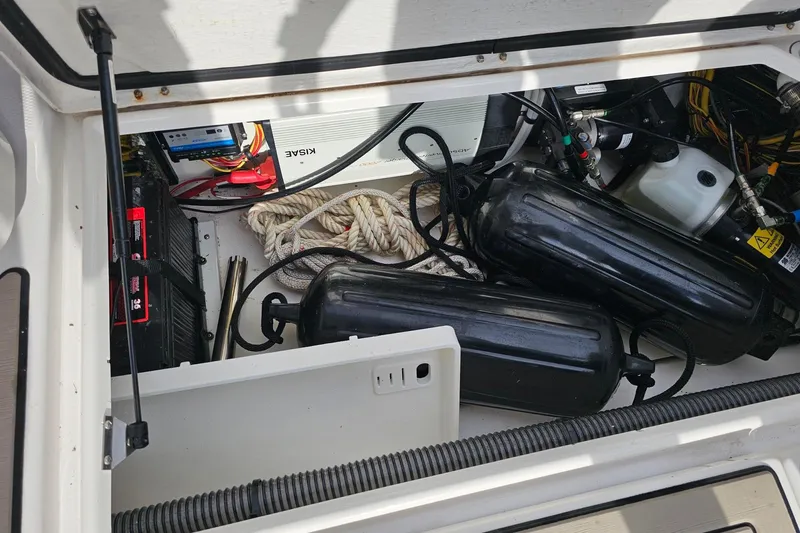 Frisky Yacht Photos Pics Open storage compartment of 2022 Cuwater C-32-CB boat with ropes and equipment.