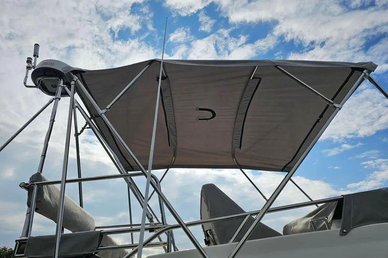 Frisky Yacht Photos Pics Cuwater C-32-CB boat canopy with metal frame against a cloudy sky, 2022 model.