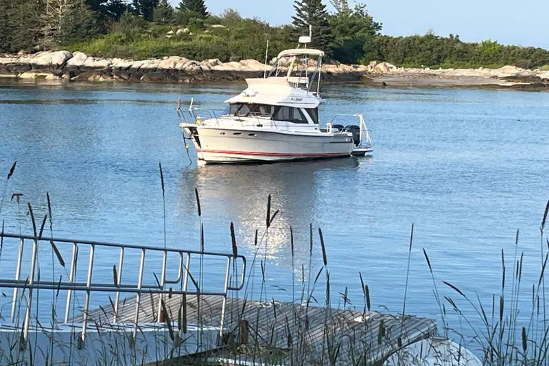 Frisky Yacht Photos Pics Boat "Cuwater C-32-CB" 2022 model anchored in scenic coastal waters.