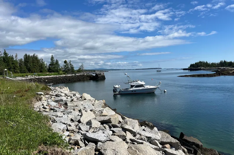 Frisky Yacht Photos Pics Boat "Cuwater C-32-CB" 2022 model anchored in scenic coastal bay.