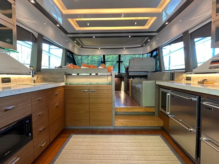 Do It All Yacht Photos Pics Luxurious interior of 2019 Tiara Yachts C53 with modern kitchen and seating area.