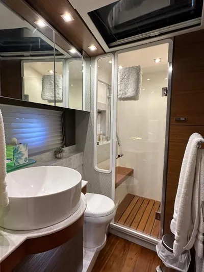 Do It All Yacht Photos Pics Luxurious bathroom in a 2019 Tiara Yachts C53 with modern fixtures and wooden accents.