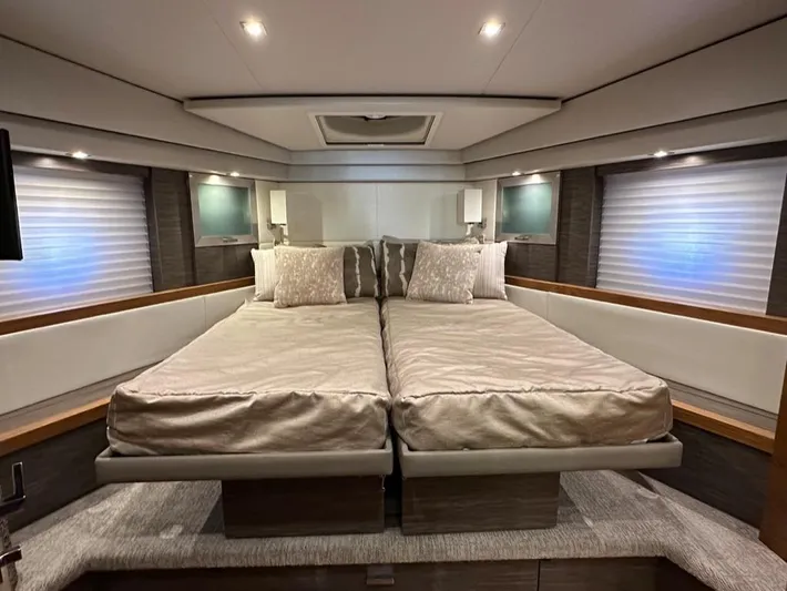 Do It All Yacht Photos Pics Luxurious bedroom interior of 2019 Tiara Yachts C53 with twin beds and modern lighting.