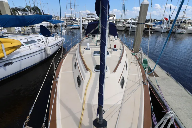 Migaloo Yacht Photos Pics 1996 Island Packet 40 sailboat docked at marina, surrounded by other boats.
