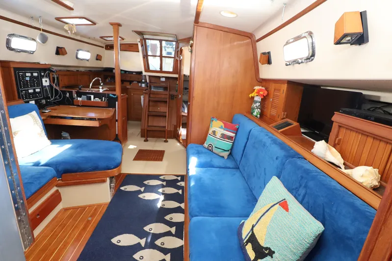 Migaloo Yacht Photos Pics Interior of 1996 Island Packet 40 sailboat with blue seating and nautical decor.