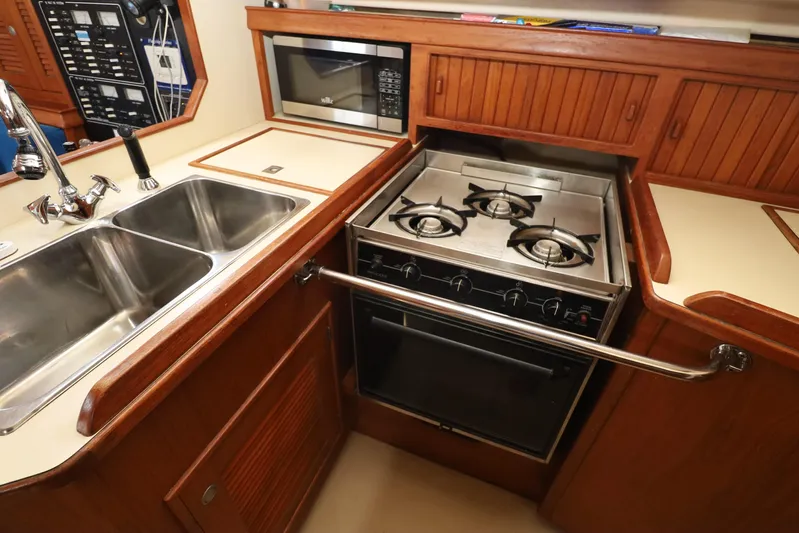 Migaloo Yacht Photos Pics Island Packet 40 yacht kitchen with stove, sink, and microwave, 1996 model.