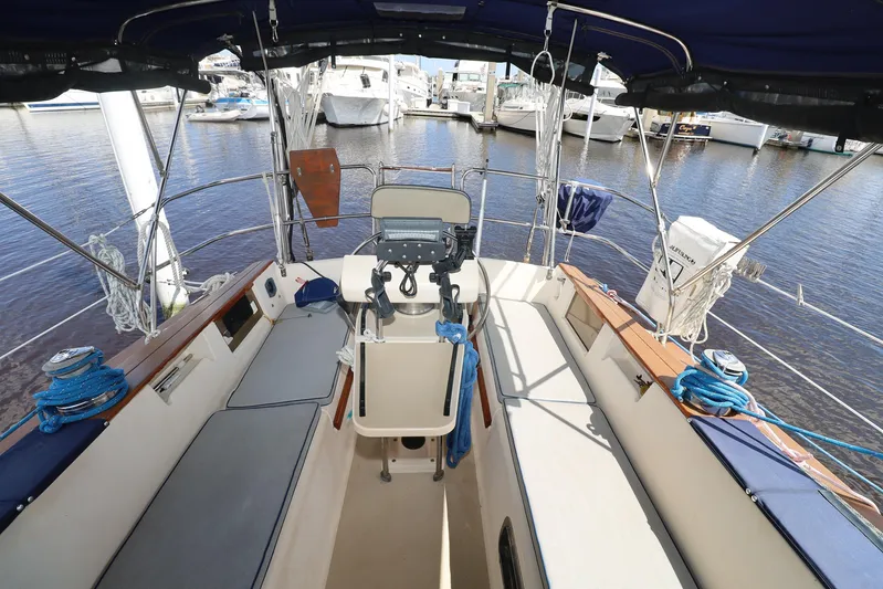 Migaloo Yacht Photos Pics Cockpit view of a 1996 Island Packet 40 sailboat docked at a marina.