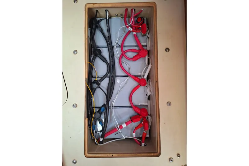 Migaloo Yacht Photos Pics Battery compartment of a 1996 Island Packet 40 sailboat with red and black cables.