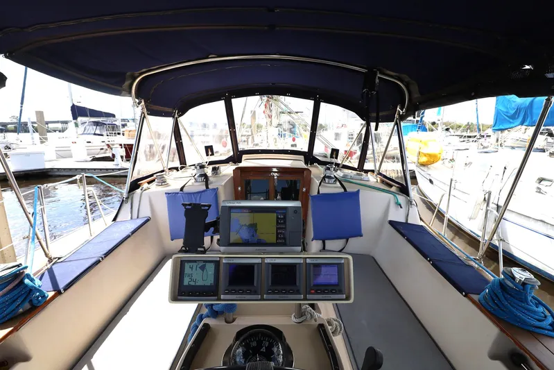 Migaloo Yacht Photos Pics Cockpit view of a 1996 Island Packet 40 sailboat with navigation equipment and seating.