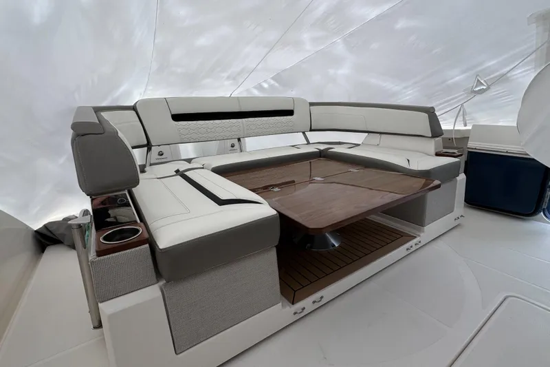  Yacht Photos Pics Luxurious seating area on 2022 Tiara Yachts 43 LS with elegant wood table and cup holders.
