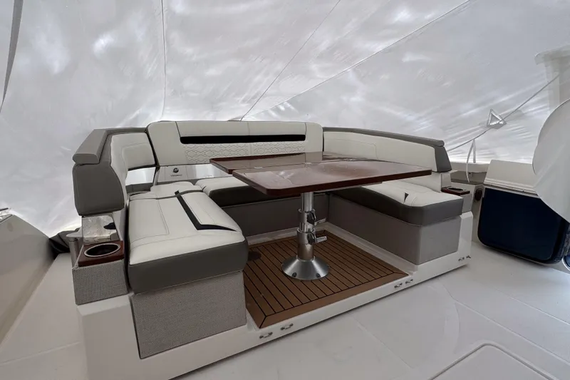  Yacht Photos Pics Luxurious seating area on 2022 Tiara Yachts 43 LS with elegant table and cushioned seats.