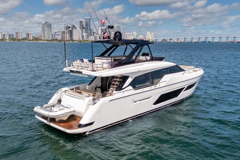Santa Maria Yacht Photos Pics 2024 Ferretti Yachts 720 cruising near city skyline and bridge on a sunny day.