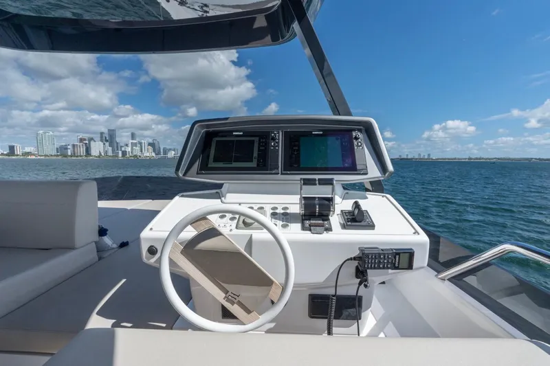Santa Maria Yacht Photos Pics Helm of 2024 Ferretti Yachts 720 with city skyline and ocean view.
