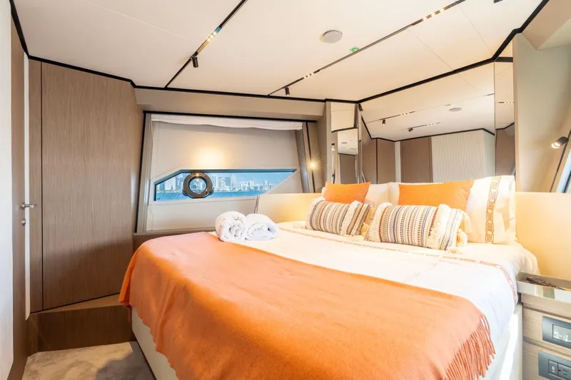 Santa Maria Yacht Photos Pics Luxurious bedroom interior of 2024 Ferretti Yachts 720 with elegant decor and city view.
