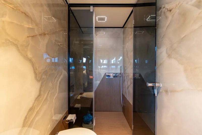 Santa Maria Yacht Photos Pics Luxurious bathroom interior on 2024 Ferretti Yachts 720, featuring elegant marble walls and glass shower.