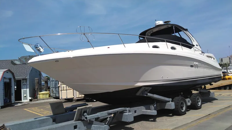 Barely "a" Wake Yacht Photos Pics 2004 Sea Ray 340 Sundancer boat on a trailer at a marina.