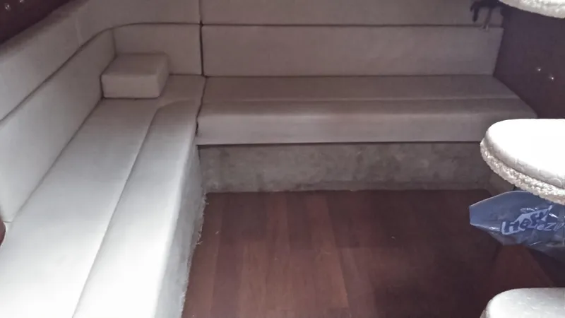 Barely "a" Wake Yacht Photos Pics Interior seating area of a 2004 Sea Ray 340 Sundancer boat with beige upholstery.