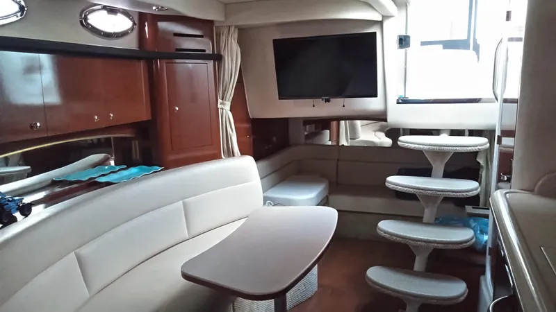 Barely "a" Wake Yacht Photos Pics Interior of 2004 Sea Ray 340 Sundancer yacht with seating, table, and stairs.