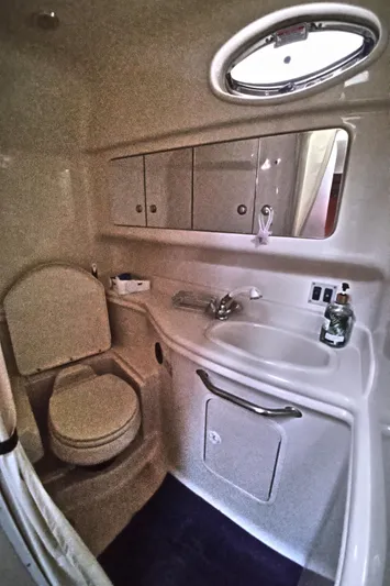 Barely "a" Wake Yacht Photos Pics 2004 Sea Ray 340 Sundancer bathroom with sink, toilet, and storage cabinets.
