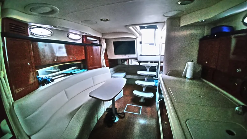 Barely "a" Wake Yacht Photos Pics Interior of 2004 Sea Ray 340 Sundancer yacht with seating, table, and kitchenette.
