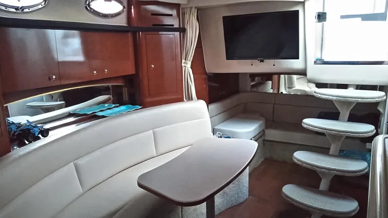 Barely "a" Wake Yacht Photos Pics Interior of 2004 Sea Ray 340 Sundancer yacht with seating, table, and TV.