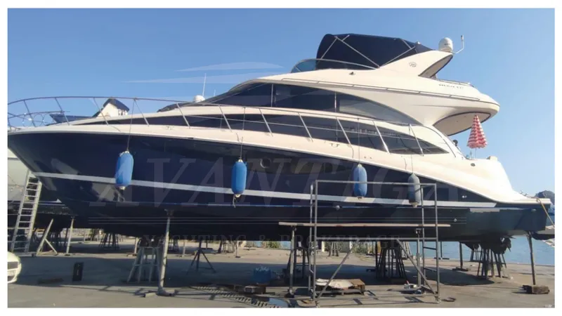  Yacht Photos Pics 2010 Meridian 541 Sedan yacht on dry dock with blue fenders, side view.