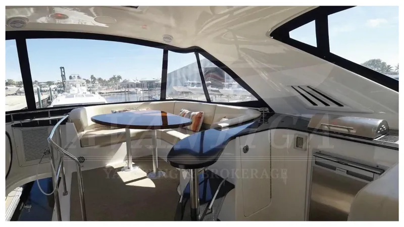 Yacht Photos Pics Luxurious interior of 2010 Meridian 541 Sedan yacht with panoramic windows and elegant seating area.