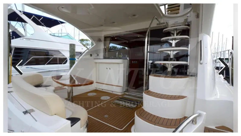  Yacht Photos Pics 2010 Meridian 541 Sedan yacht interior with seating, table, and spiral staircase.