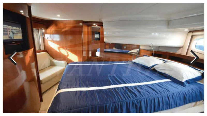  Yacht Photos Pics Luxurious interior of 2010 Meridian 541 Sedan yacht with cozy bed and elegant wood finishes.