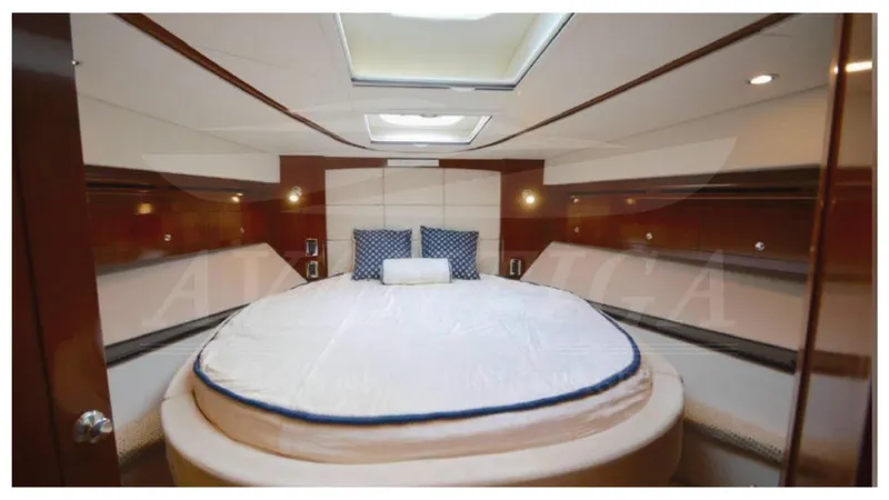  Yacht Photos Pics Luxurious bedroom interior of 2010 Meridian 541 Sedan yacht with round bed and skylight.
