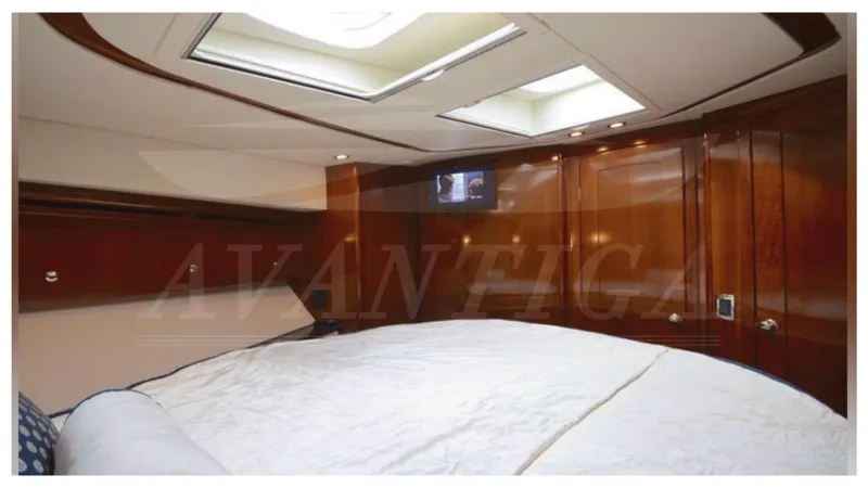  Yacht Photos Pics Luxurious cabin interior of 2010 Meridian 541 Sedan yacht with wood paneling and skylights.