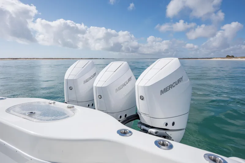  Yacht Photos Pics 2014 Yellowfin 42 Offshore boat with triple Mercury outboard engines on calm sea.