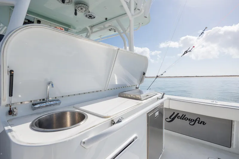  Yacht Photos Pics 2014 Yellowfin 42 Offshore boat with sink and storage, set against a serene ocean backdrop.