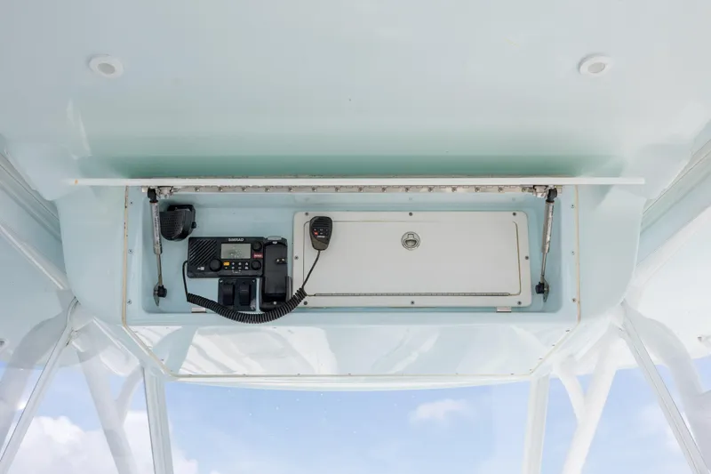  Yacht Photos Pics 2014 Yellowfin 42 Offshore boat console with radio equipment and storage compartment.