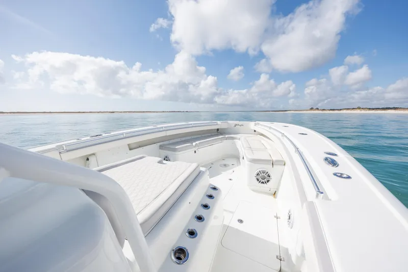  Yacht Photos Pics 2014 Yellowfin 42 Offshore boat on calm sea under blue sky with clouds.