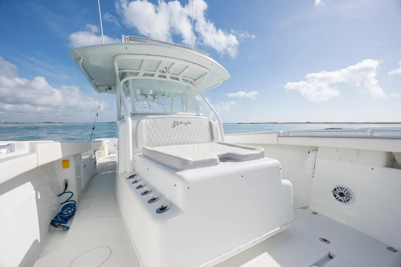  Yacht Photos Pics 2014 Yellowfin 42 Offshore boat with spacious deck and seating, under clear blue sky.