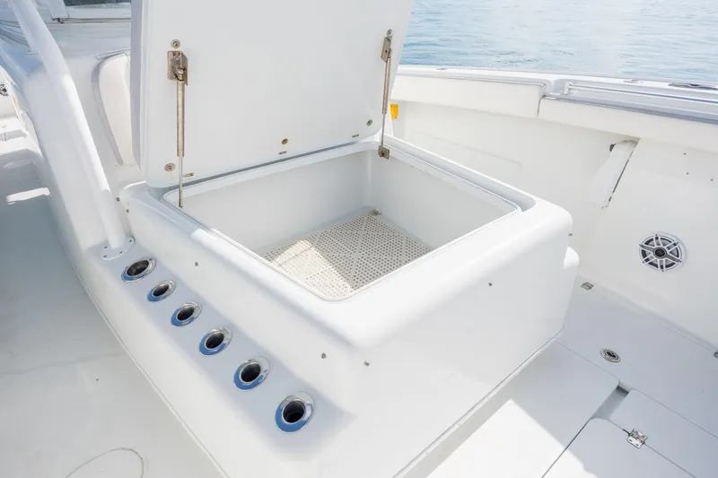  Yacht Photos Pics Open storage compartment on 2014 Yellowfin 42 Offshore boat, featuring rod holders and speaker.