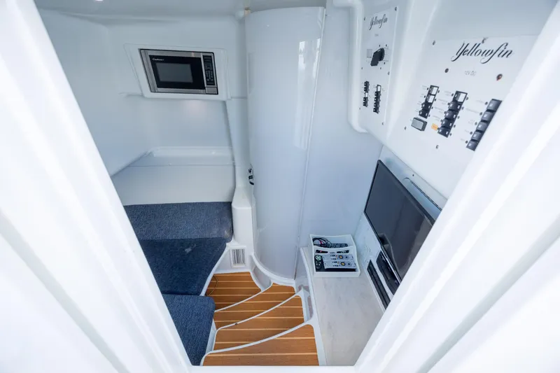 Yacht Photos Pics Interior of 2014 Yellowfin 42 Offshore boat with seating, microwave, and control panels.