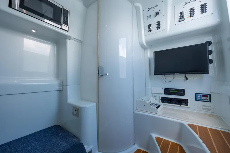  Yacht Photos Pics 2014 Yellowfin 42 Offshore cabin with microwave, TV, and control panels.