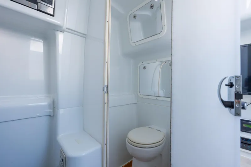  Yacht Photos Pics 2014 Yellowfin 42 Offshore boat bathroom with white interior and compact design.