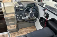 2022 Finnmaster T7 boat cockpit with steering wheel and control panel.