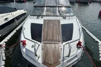 2022 Finnmaster T7 boat docked, featuring sleek design and wooden deck accents.